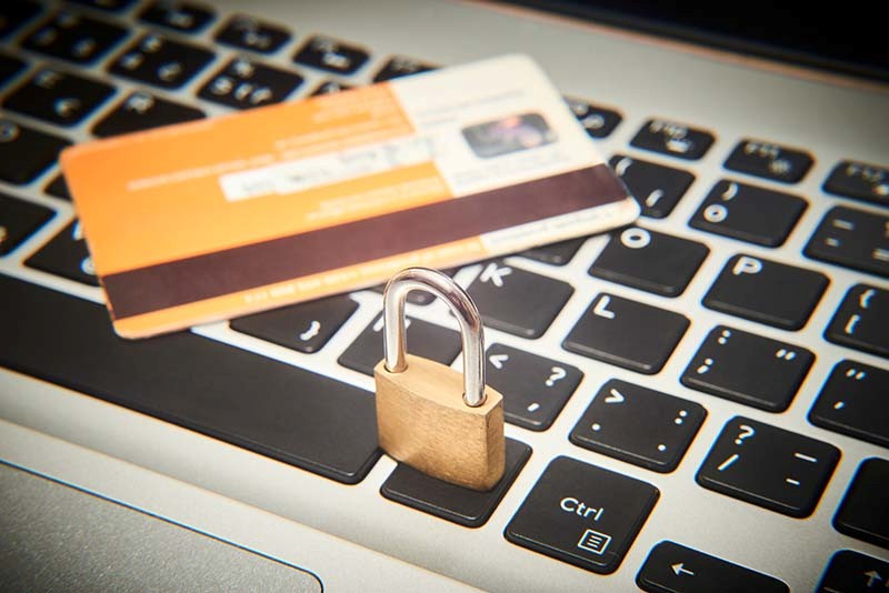 padlock and credit card on computer keyboard